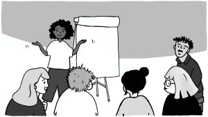 A person gestures at a whiteboard while speaking to a group of people